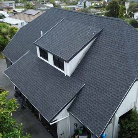 Charcoal asphalt shingle roof on an Auckland home after a concrete tile to shingle conversion