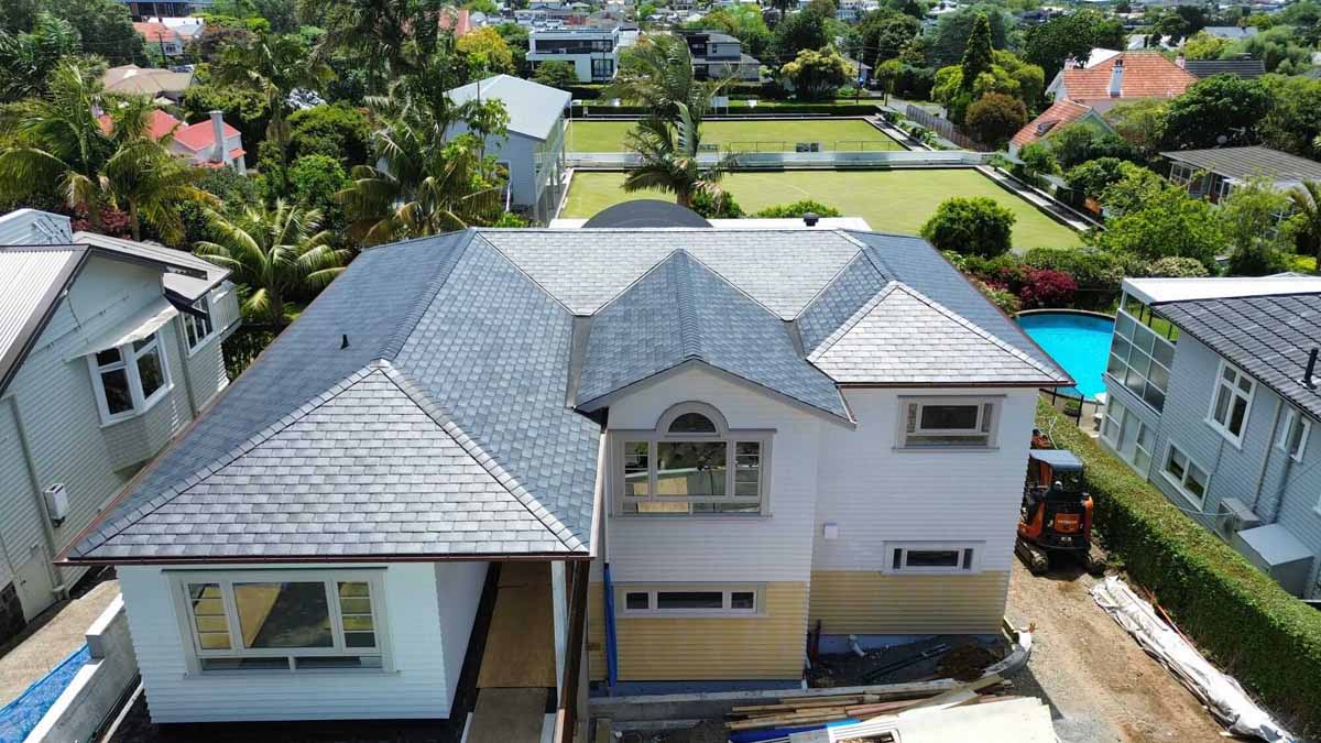 Large two-storey New Zealand home with a premium asphalt shingle roof viewed from above during a roofing project Large two-storey New Zealand home with a premium asphalt shingle roof viewed from above during a roofing project