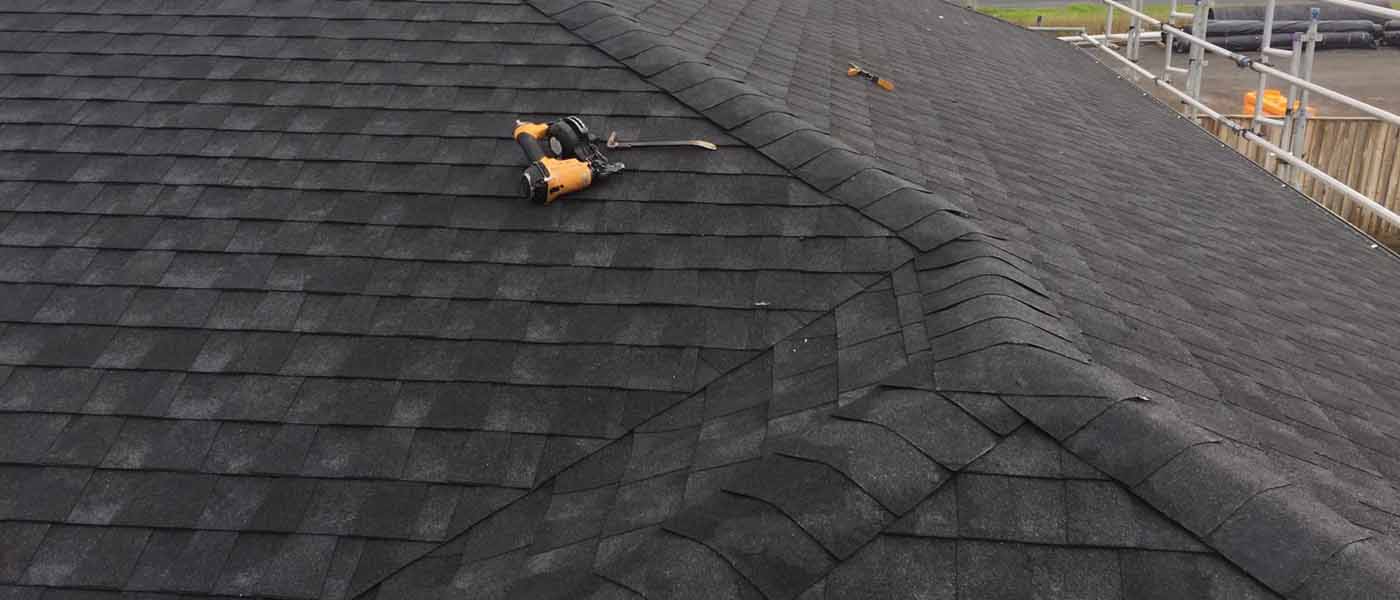 Close up of a neatly finished asphalt shingle roof valley on an Auckland project