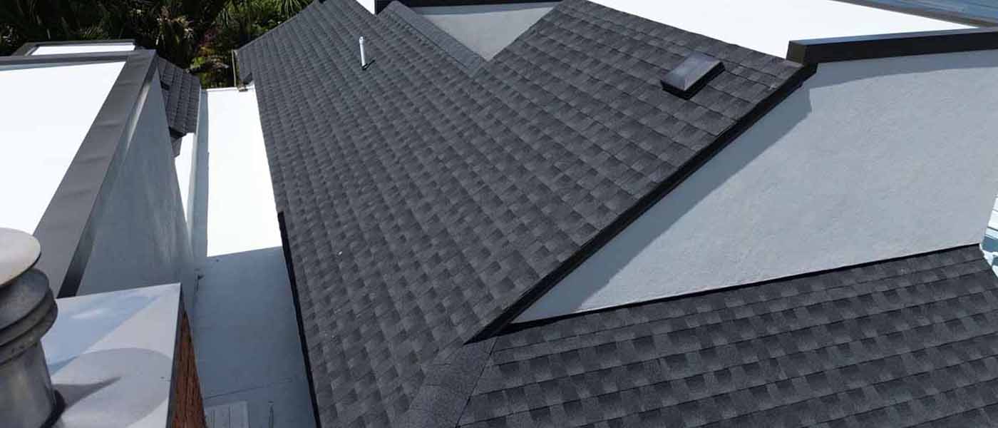 Architectural GAF asphalt shingle roof with hips, valleys and skylight on a modern Auckland home